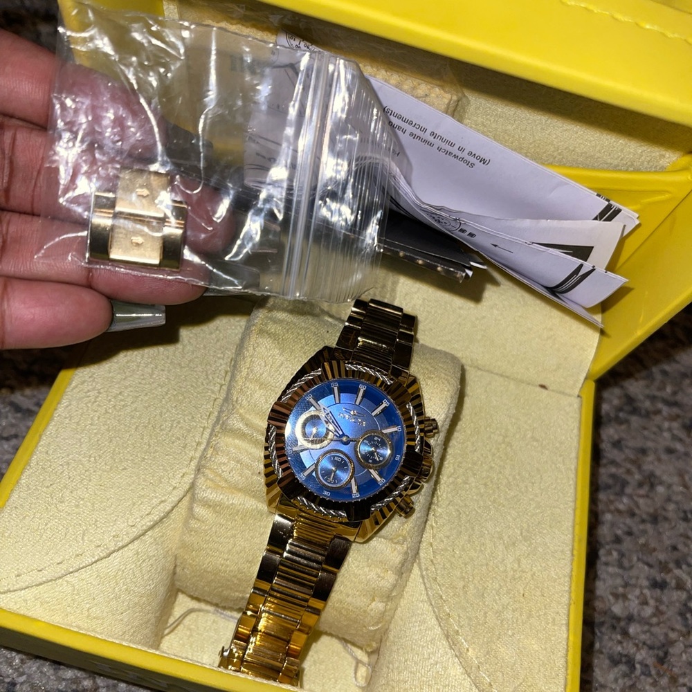 Gold Invicta watch with blue face